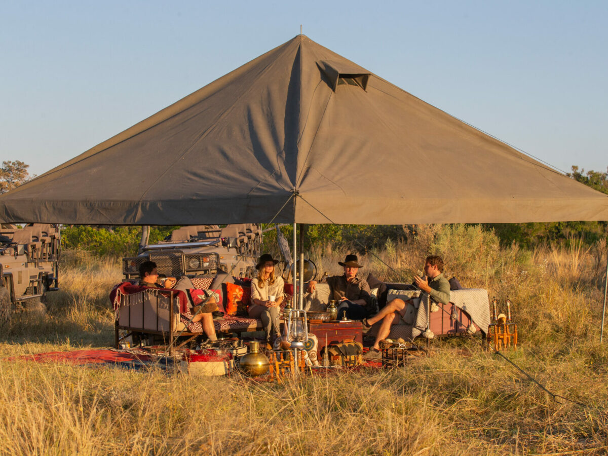 a sunset view of a golden africa safari tent out in the bush