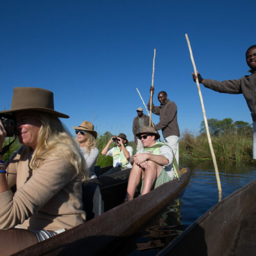 tourists seated in canoe's on a river with Golden Africa Safaris