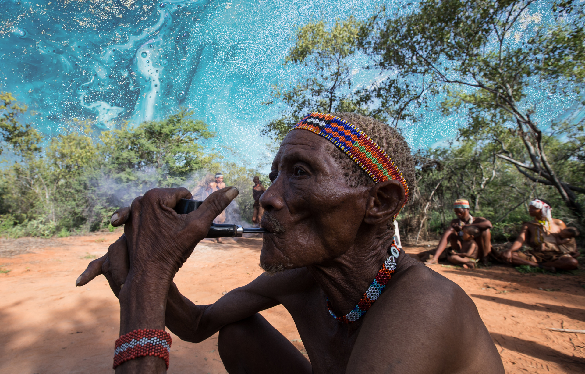 Khoi San man smoking a pipe near Botswana Tented Camp