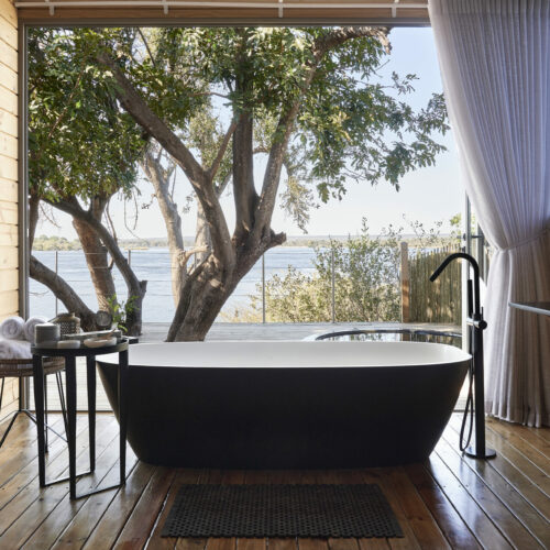 Bathroom view out over the river of an Island Treehouse suite