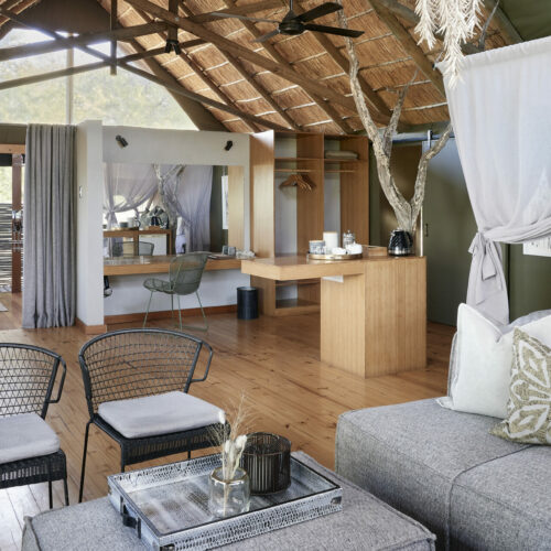 interior of a luxury bedroom and lounge at Victoria Falls River Lodge