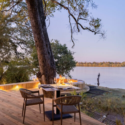 chairs and table on the deck at the Victoria Falls River Lodge