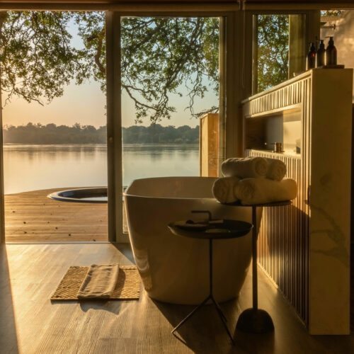 Bathroom view of the deck and river at Victoria Falls River Lodge