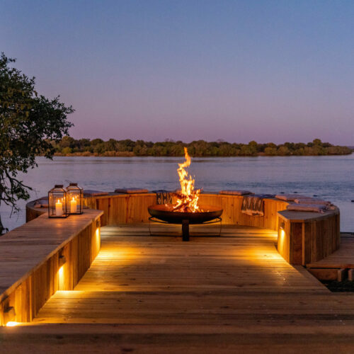 deck with bonfire at night overlooking the Zambezi River